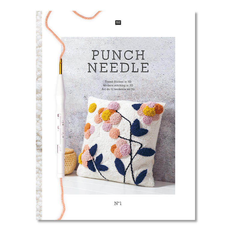 Heft 'Punch Needle' mit einem Kissen und Blumenmuster.