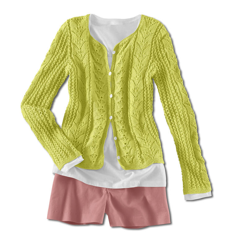 Lochmusterjacke in hellem Grün, lässig auf einem weißen Hemd drapiert.