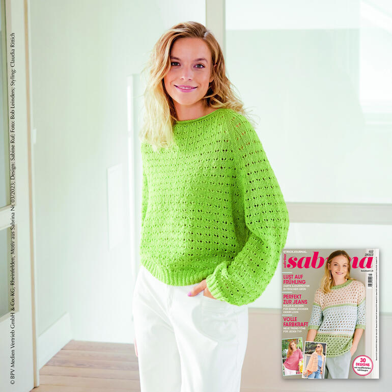 Leuchtend grüner Raglan-Pullover mit einem luftigen Design.