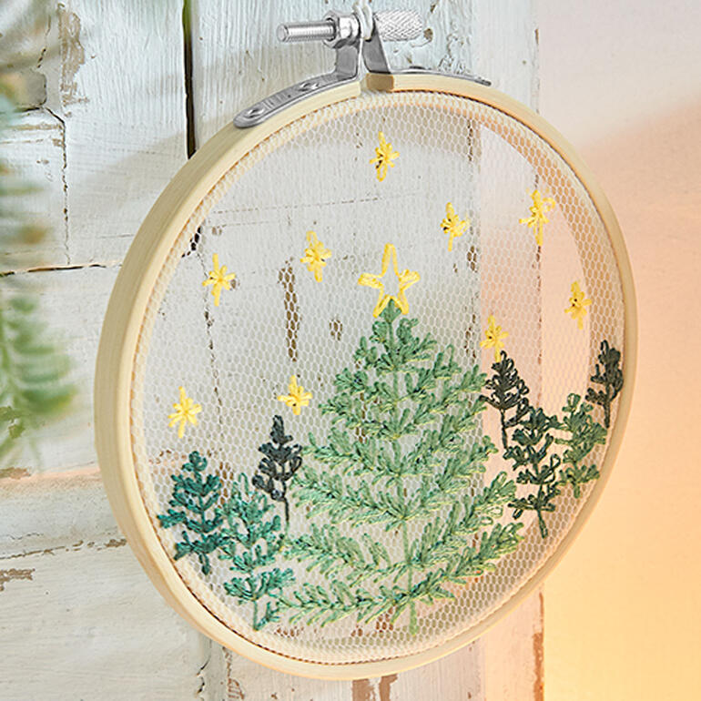 Tüll-Stickbild eines Weihnachtsbaums mit Sternen.